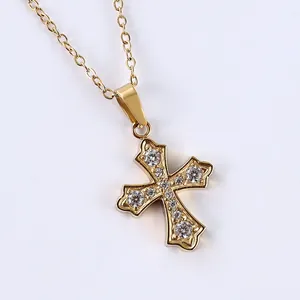 Macro shot of gold stainless steel cross necklace featuring sparkling pave-set zircons