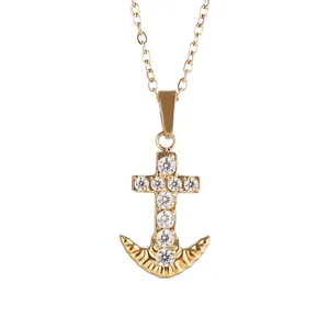 Close-up of gold plated anchor cross pendant featuring micro-set sparkling zircons