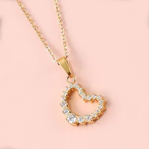Macro view of 18K gold heart necklace pendant with micro-pave cubic zirconia crystals