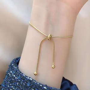 Detail of adjustable 18K gold plated stainless steel snake chain necklace with sliding bead