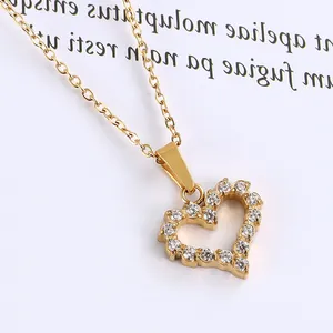 Macro shot of 18K gold heart pendant necklace with micro-paved sparkling zircon details