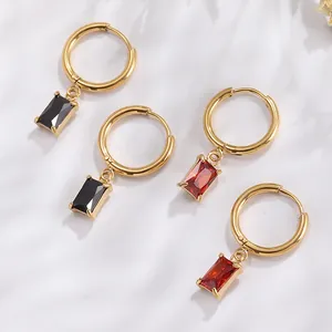 Detail of 18K gold-plated hoop earrings with rectangular black and red zircon pendants