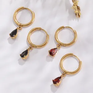 Close-up of gold stainless steel hoop earrings with black and red teardrop zircon stones