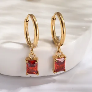 Detail of 18K gold plated hoop earrings with red rectangular zircon pendant detail