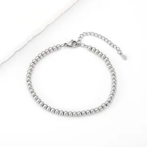 Detail of 4mm stainless steel beaded bracelet featuring a lobster clasp and adjustable chain