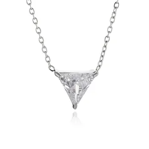 Macro shot of silver 18K gold necklace featuring a brilliant triangle zircon pendant