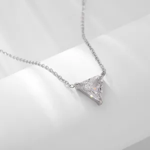Detailed close-up of a triangle-cut zircon pendant with a polished silver-tone metal chain