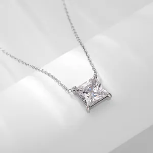 Macro detail of square princess-cut zircon pendant with four-prong silver chain setting