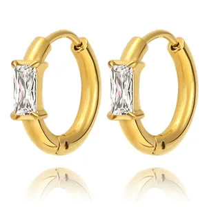 Macro shot of gold square baguette zircon hoop earrings in polished stainless steel
