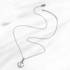 Detailed view of silver anchor pendant with white zircon and adjustable lobster clasp