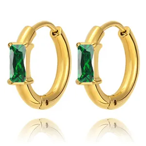 Detail of gold hoop earrings featuring rectangular emerald green zircon stones