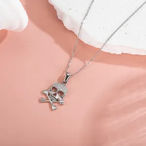 Close-up of silver skull pendant with sparkling zircons and fine link chain