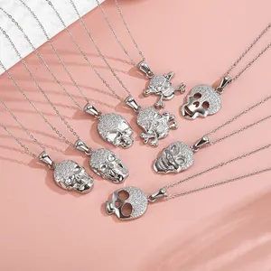 Macro view of assorted silver skull pendants with micro-inlaid cubic zirconia details