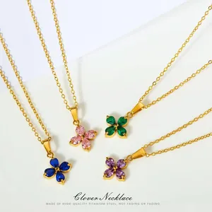 Detailed close-up of four-leaf clover necklaces with multi-color zircon stones and gold chains
