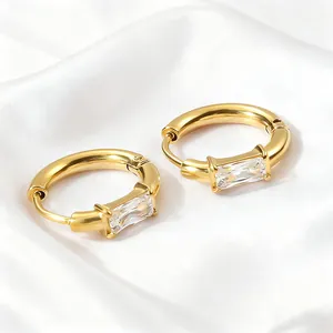 Elegant gold huggie earrings featuring a rectangle baguette-cut zircon in a minimal style