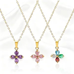Three gold clover necklaces with purple, pink and multicolor cubic zirconia on silk