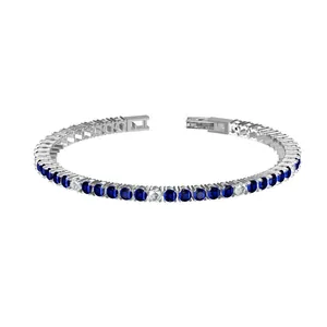 Macro detail of stainless steel tennis bracelet with blue and white cubic zirconia