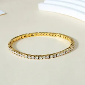 Detail of classic 3mm tennis bracelet with gold finish and cubic zirconia inlay
