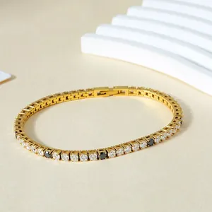 Macro view of gold tennis bracelet with alternating black and white zircon stones