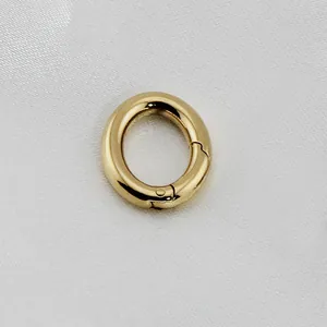 Macro shot of a polished gold oval spring gate hook for bags and jewelry making