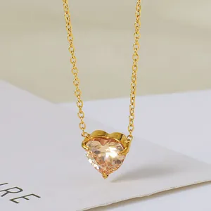 Detailopname van champagne hartvormige zirkoon hanger met gouden roestvrijstalen ketting