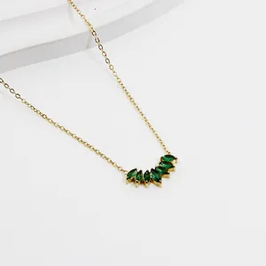 Nahaufnahme der goldenen Halskette mit smaragdgrünen Zirkonia im fächerförmigen Design