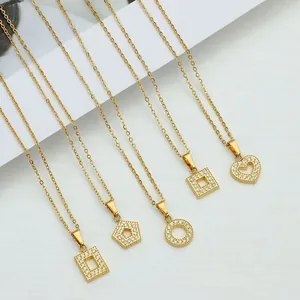 Detail of five gold geometric necklaces with zircon square and heart-shaped pendants