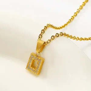 Macro view of gold rectangle hollow pendant with white cubic zirconia on O-chain