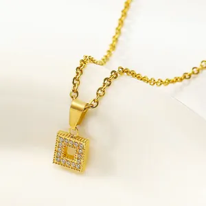 Detail of a square hollow gold necklace pendant with sparkling zircon stones