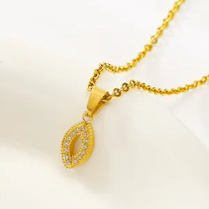 Macro view of a gold titanium necklace featuring a marquise-shaped pendant with zircons