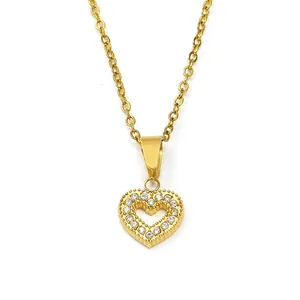 Detail shot of heart-shaped gold pendant with cubic zirconia on a square frame necklace
