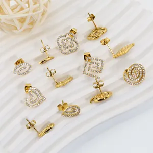 Macro shot of gold-plated titanium earrings with micro-pave white zircon stones