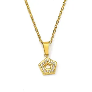 Macro detail of gold pentagon pendant with micro-paved cubic zirconia on O-chain necklace