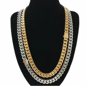 Polished gold and silver Cuban link necklaces with secure box clasp on a neck display