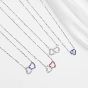 Titanium steel heart necklaces with colorful zircon stones on white silk fabric