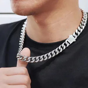 Close-up of thick silver-tone Cuban link necklace with a secure rectangular clasp