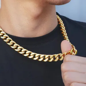 Detailed view of heavy gold plated Cuban link chain necklace on black T-shirt