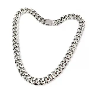 Macro detail of silver stainless steel Cuban link chain with secure rectangular box clasp
