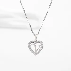 Close-up of a silver heart pendant with a hollow letter V and micro-pave zirconia crystals