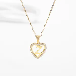 Detail of heart pendant with Z initial and crystals on gold titanium steel necklace