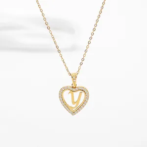 Macro shot of gold heart-shaped pendant with letter Y and sparkling pavé crystals