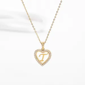 Macro shot of 18K gold plated heart pendant with pavé diamonds and the letter T