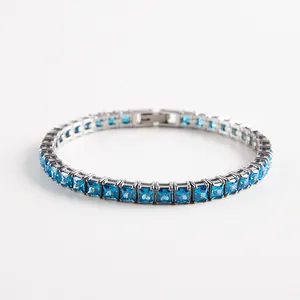 Close-up of silver-tone tennis bracelet with square-cut sky blue cubic zirconia gems