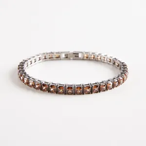 Detail of silver tennis bracelet with square-cut brown cubic zirconia and fold-over clasp