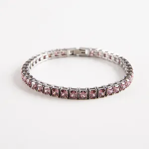 Macro shot of silver tennis bracelet featuring square-cut pink zircons and hidden clasp
