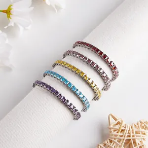 Five colorful square-cut zircon tennis bracelets on a display roll with white accents