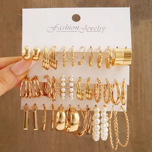 18-piece gold earring set with twisted hoops and pearls on display cards