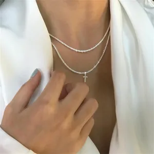 Double-layered silver necklace with tennis chain and minimalist cross pendant for women