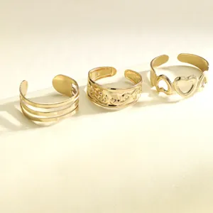 Three-piece gold adjustable ring set featuring hollow heart and embossed band designs
