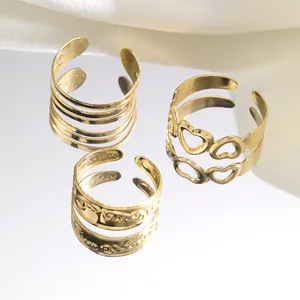 Close-up of a three-piece gold hollow heart and multi-layer adjustable open ring set
